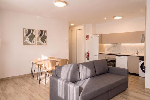 a living room with a couch and a table at InsideHome Ciudad de Valladolid in Valladolid