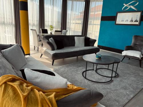 a living room with couches and a table at L&A Apartments in Dragash