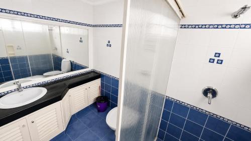 a bathroom with a sink and a toilet at Sky Villa in Trichūr