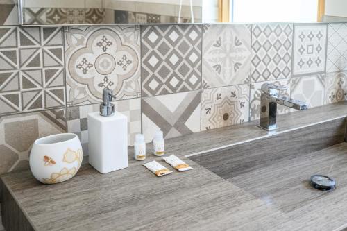 a bathroom counter with a sink and a faucet at Alpine Aura Loft- Privacy, Relax, Mountain View in Saint-Christophe