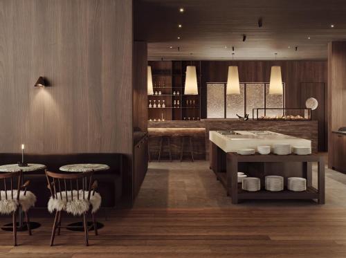 a restaurant with a tub and a table and chairs at Halo Igloos Resort in Rovaniemi