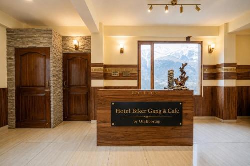 a lobby with a hotelier car care and cafe sign at Hotel Biker Gang Hotel & Cafe in Kyelang