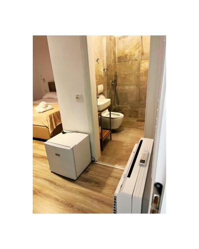 a room with a bathroom with a toilet and a sink at Vila Sofia Gllava - Resort in Memaliaj