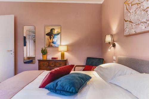 a bedroom with two beds and a chair at My Tuscany Pink Suite in San Quirico dʼOrcia