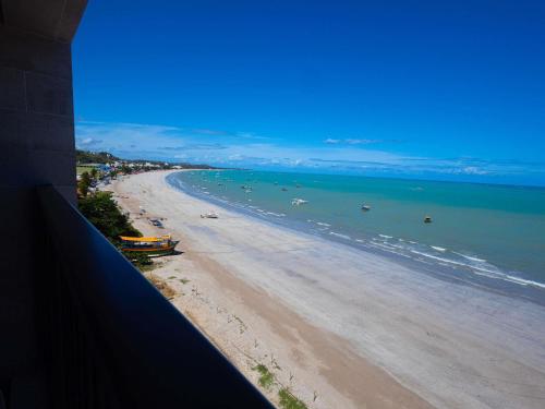 a view of a beach with boats in the water at Ibis Styles Maragogi in Maragogi