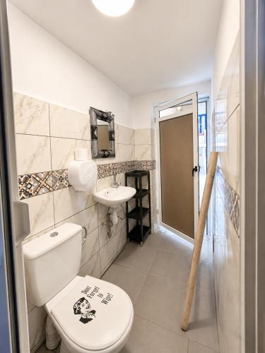 a bathroom with a toilet and a sink at Yousurf Surf House in Essaouira