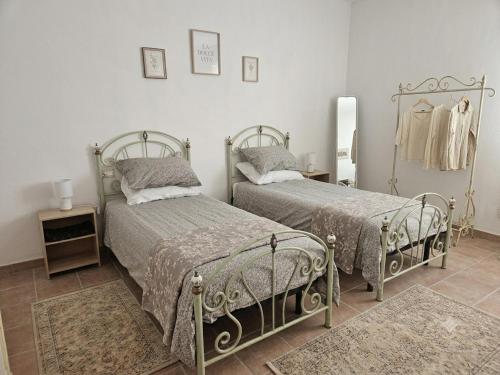 a bedroom with two beds and a mirror at Cascina Tesoriera in Santhià