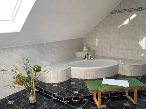 a large bathroom with a tub and a table at Ferienhaus Barth in Bad Salzungen