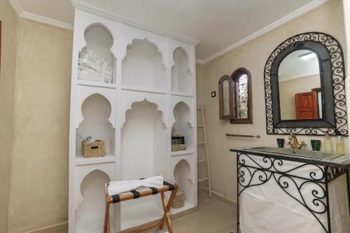 a bathroom with a sink and a mirror at Palais Zoya in Marrakesh