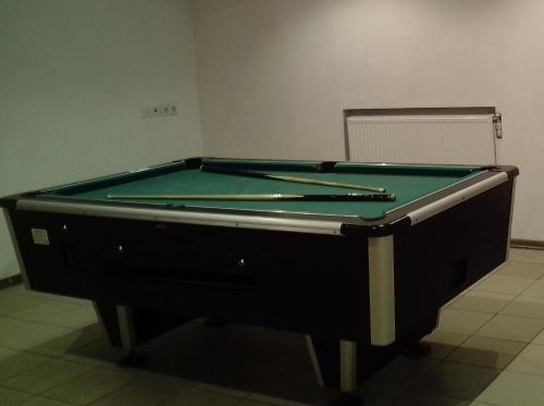 a pool table in a room with afits at Travel home in Riga