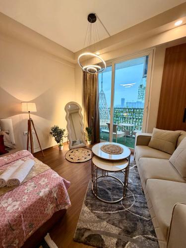 a living room with a couch and a table at R&R Eleanor Suites in Greater Noida
