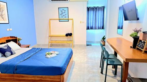 a hotel room with a bed and a desk at The cabana guesthouse in Cha Am