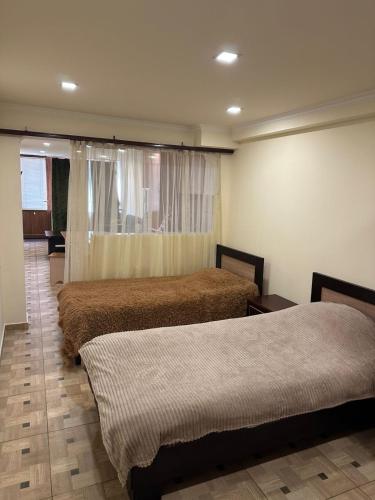 a room with two beds and a window at Villa hills II in Yerevan