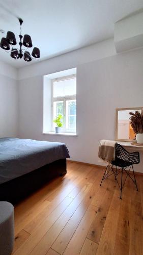 a bedroom with a bed and a desk and a window at Lossi 32 Lux Apartment in Tartu