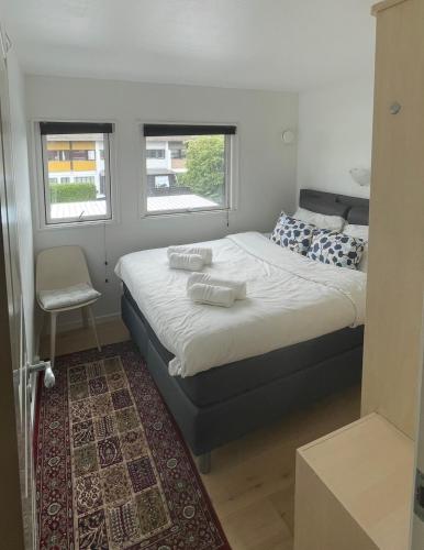 a bedroom with a bed with two pillows on it at Family home in Greve