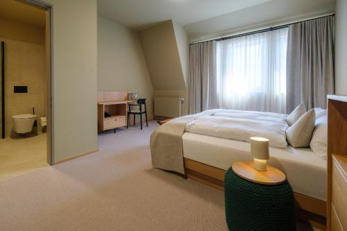 a bedroom with a bed and a large window at Haus Meeresstern in Wangerooge
