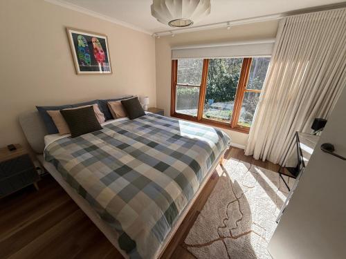 a bedroom with a bed and a window and a desk at Red Gum & Stone - Peace Space Nature in Warburton