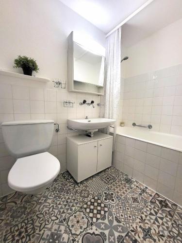 a bathroom with a toilet and a sink and a tub at Tgesa Sunnmatt 24 in Savognin