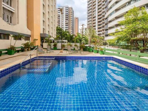 a large blue swimming pool in the middle of a building at ibis Fortaleza Praia de Iracema in Fortaleza