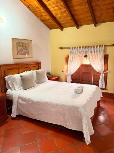 a bedroom with a large bed and a window at Real Dream Hostel in San Gil