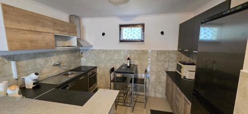 a kitchen with a sink and a counter top at Kuća za odmor BARSON in Vukovar