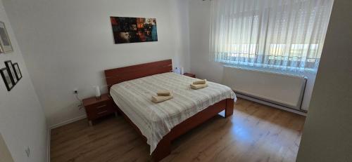 a bedroom with a bed with two towels on it at Kuća za odmor BARSON in Vukovar