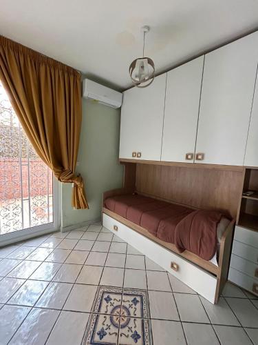 a room with a bed and cabinets and a window at Alla Chiesetta in Naples