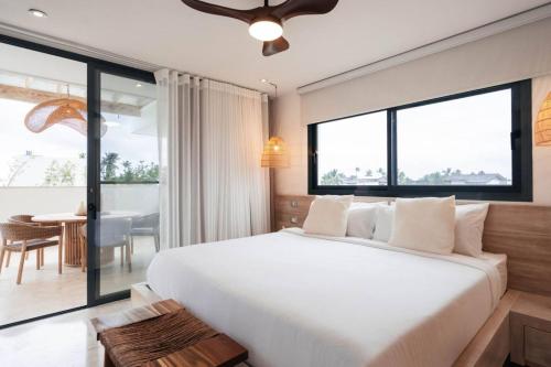 a bedroom with a large bed and a dining room at Sol de Arena Beachfront Condos by Bocobay in Las Terrenas