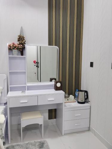 a bathroom with a white sink and a mirror at Save Sweet Home in Fuvahmulah