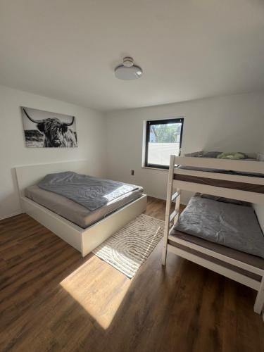 a bedroom with two bunk beds and a window at HabichtsNest Stockum in Sundern
