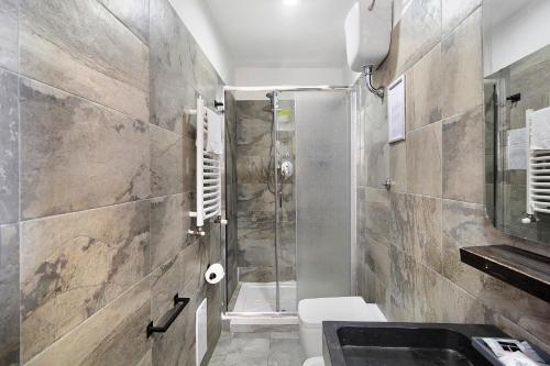 a bathroom with a shower and a toilet and a sink at Villa Fuenti Bay - Amalfi Coast in Cetara