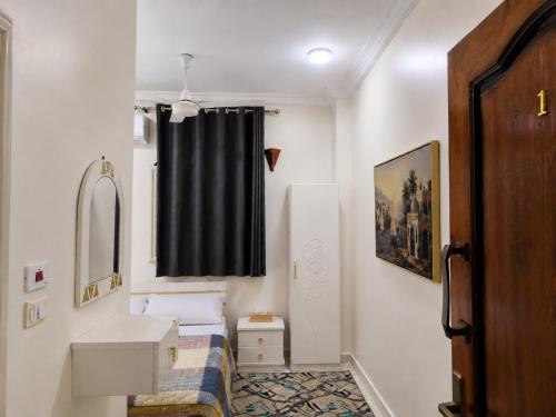 a small bathroom with a sink and a mirror at Garden view in Aswan
