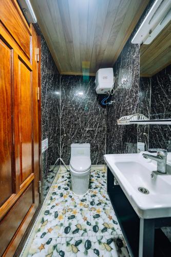 a bathroom with a sink and a toilet at Vietnam Venture Cruises in Cat Ba