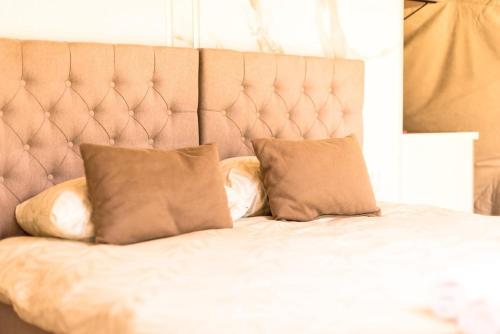 a bed with two pillows on top of it at Drivibe Glamping, Goražde in Goražde