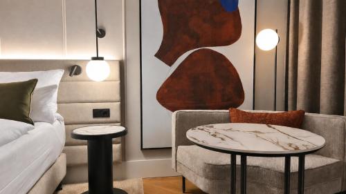 a living room with a couch and a table and a chair at Crowne Plaza Berlin City Centre Ku'damm by IHG in Berlin