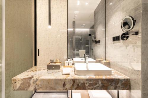 a bathroom with a sink and a shower at Radisson Hotel, Beijing DaXing Airport in Beijing