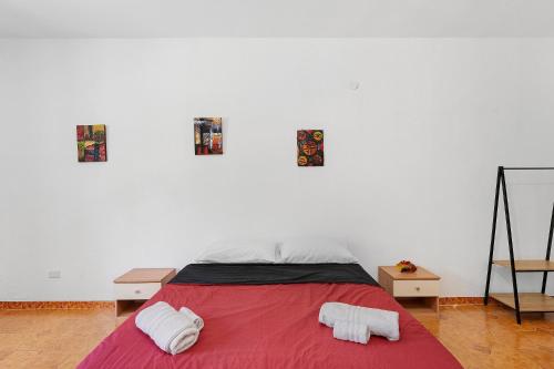 a bedroom with a bed with two towels on it at Ammentos La Casa di Rosa in Orgosolo