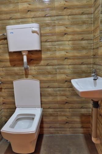 a bathroom with a toilet and a sink at Betel Leaf Resort in Māhīm