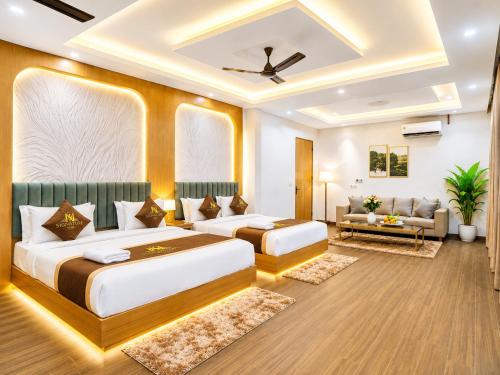 a bedroom with two beds and a living room at Hotel Ve Atlantiis Elite in New Delhi