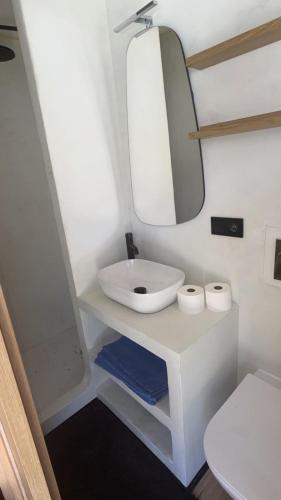 a bathroom with a white sink and a mirror at CasaNoa Boutique Guest Suites in Jávea