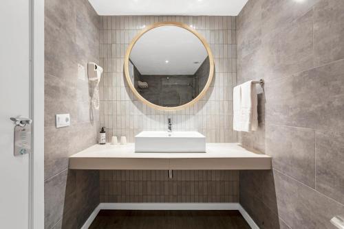 a bathroom with a sink and a mirror at HSM Sandalo Beach in Magaluf