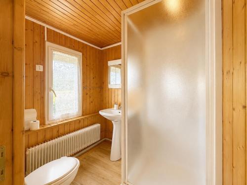 a bathroom with a shower and a toilet and a sink at Triplex Les Vignes in Vérin