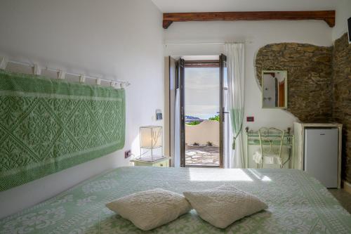a bedroom with a bed and a window with a view at Agriturismo Finagliosu in Palmadula
