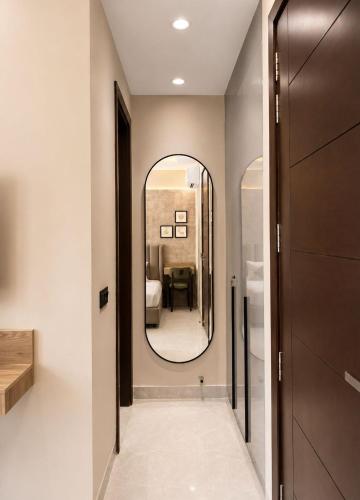 a hallway with a large mirror and a room at Lime Tree Hotel Golf Course Road, Gurgaon in Gurgaon