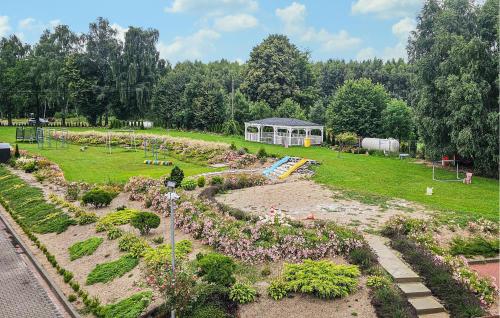 a garden with a playground and a pavilion in a park at Awesome Apartment In Dobrzyca With Wifi in Dobrzyca
