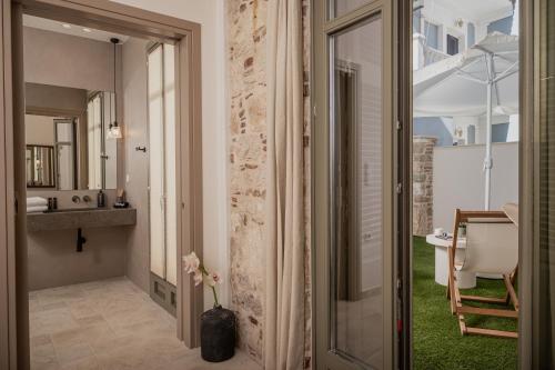a bathroom with a sink and a mirror at JUNO Collection Residences in Pythagoreio