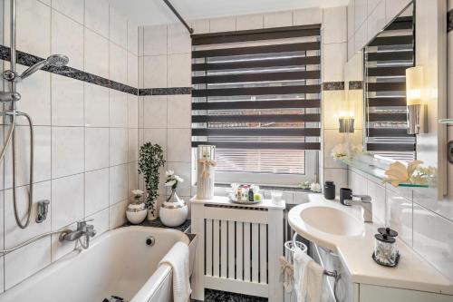 a bathroom with a tub and a sink at Landleben 2 in Erkelenz