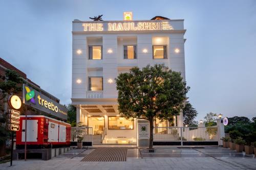 a white building with a sign that reads the miami store at Treebo Premium The Maulshri, Behind Health Vistaar City in Lucknow