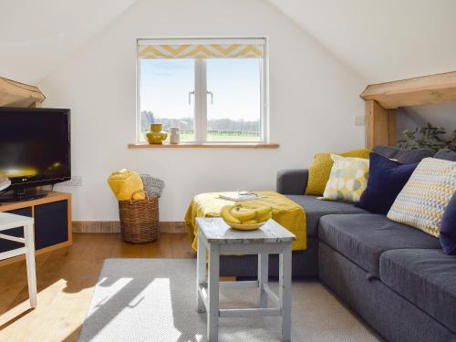 a living room with a couch and a table at Shepherd's Loft in Benson