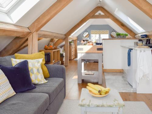 a living room with a couch and a bowl of bananas on a table at Shepherd's Loft in Benson